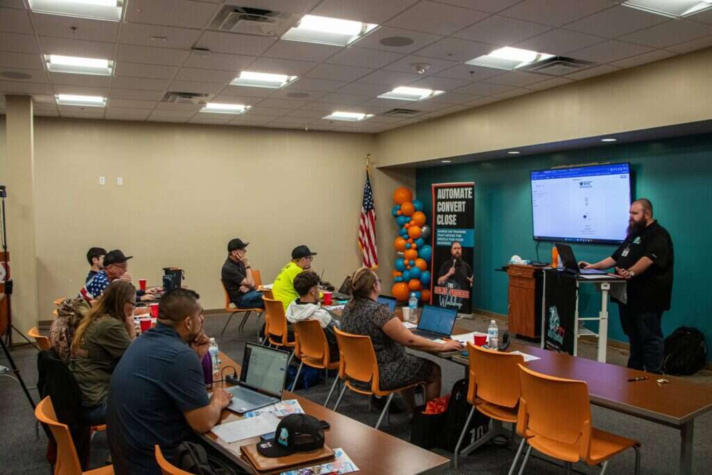 Presenter demonstrating a lead engagement system on a large display to contractors